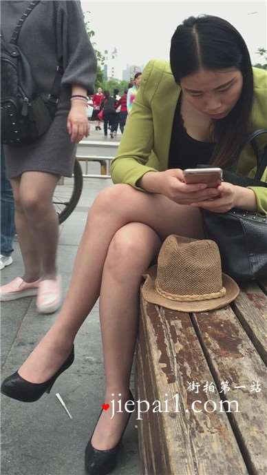 街拍性感高跟短裙美腿美女花坛边休息。