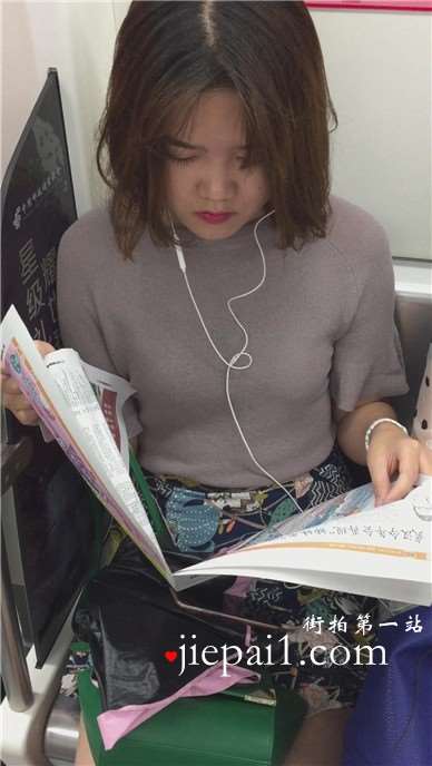 地铁上拍摄看报纸的美女，清纯甜美。