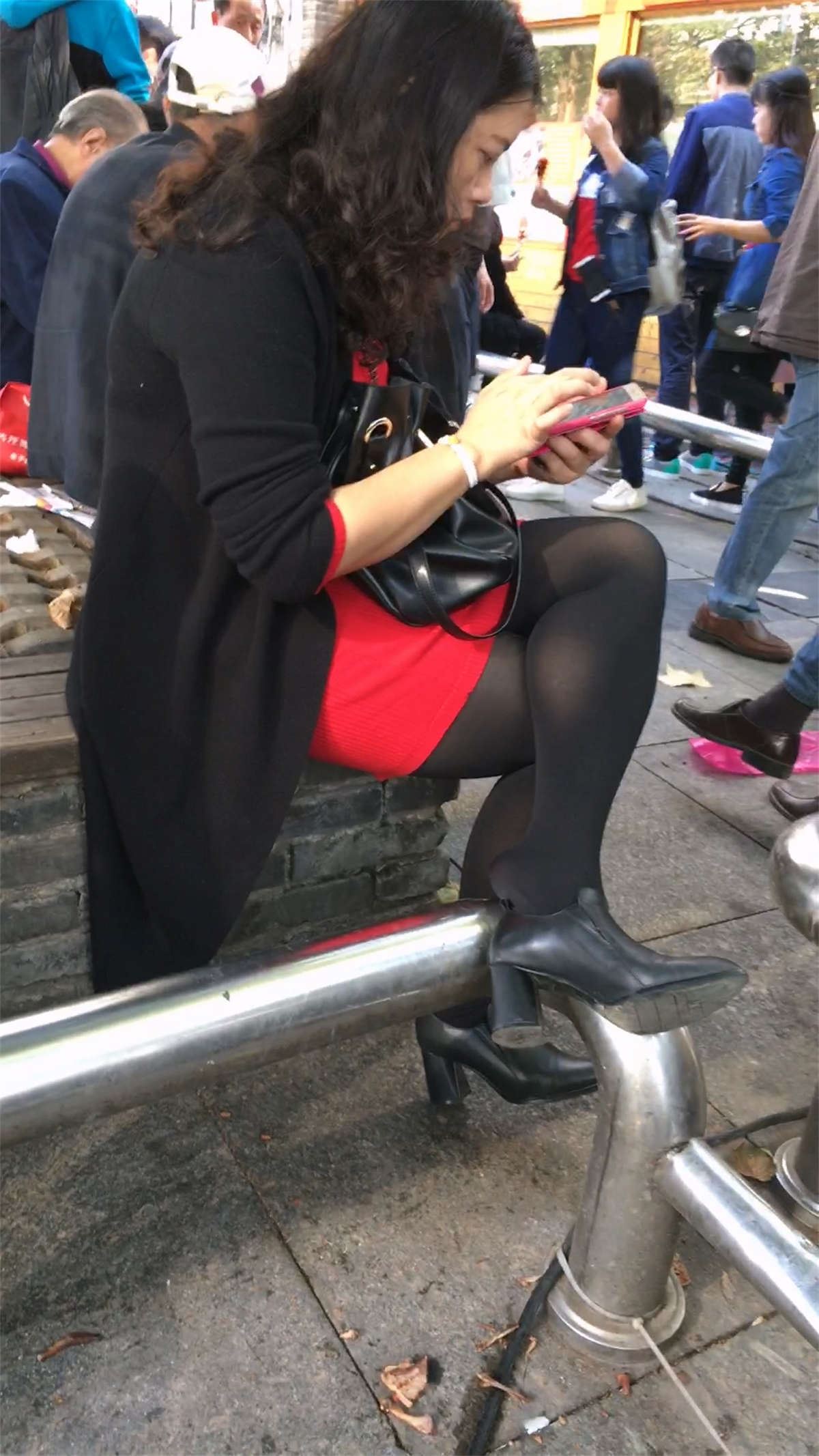花坛休息的黑色丝袜黑色高跟红色包臀裙白肤少妇