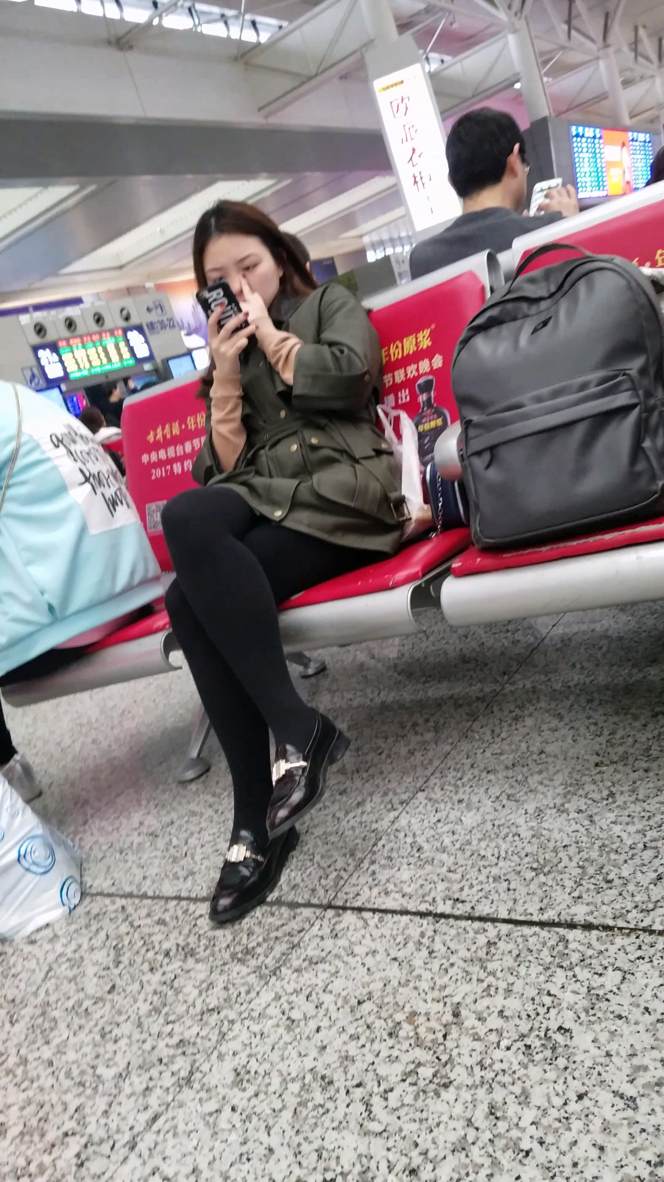 高铁站候车的黑色打底丝袜性感长腿美眉