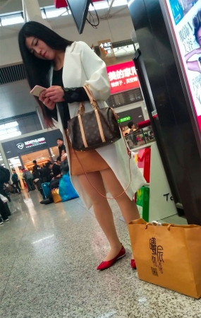 车站拍摄肉色丝袜红鞋包臀裙长发少妇