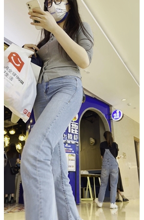 一路玩手机的牛仔美女