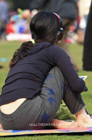 草地上听歌的女孩